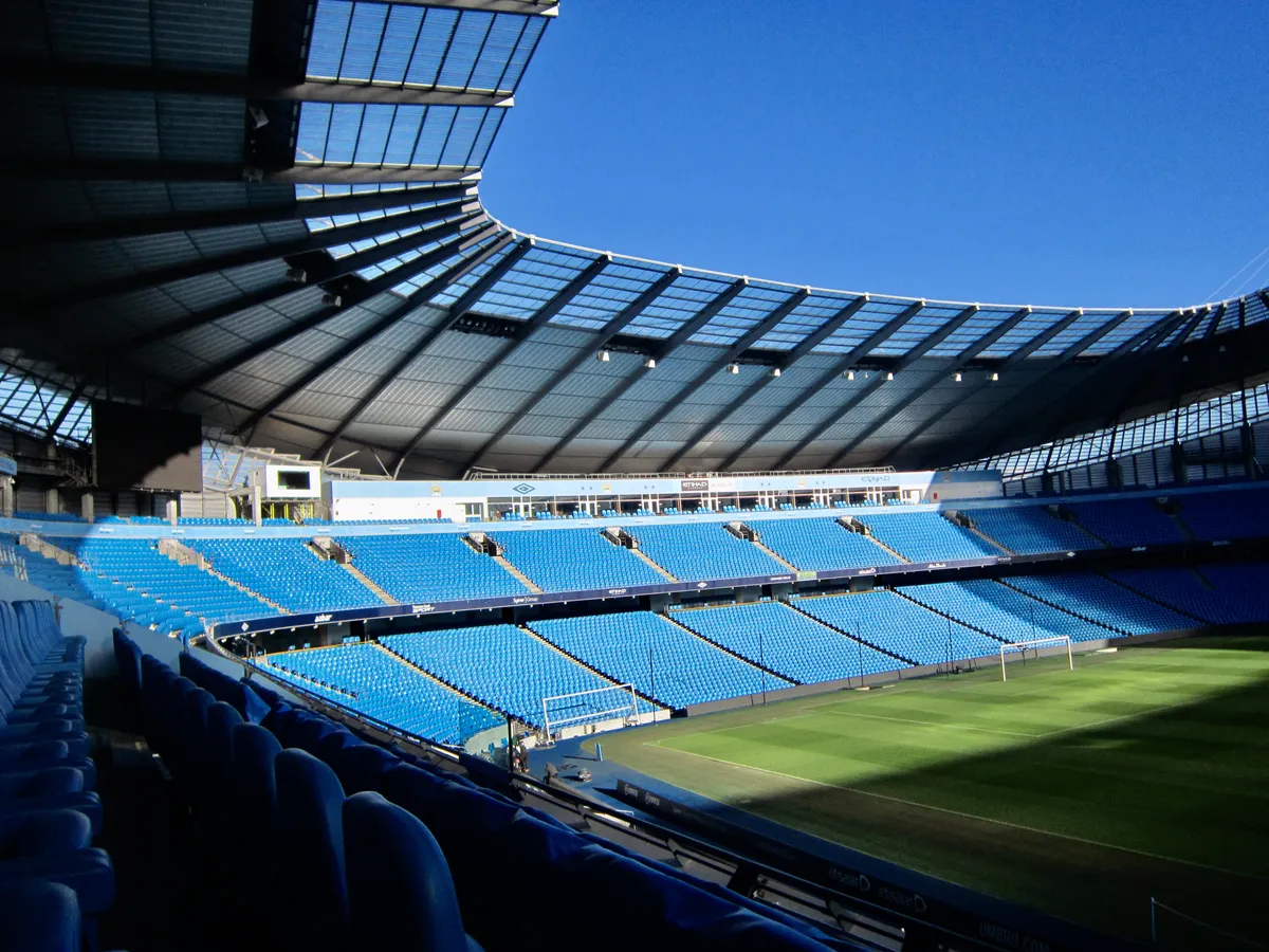 The Etihad Stadium bowl and pale blue seating seen on the Manchester City stadium tour