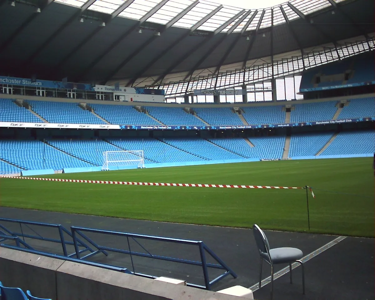 Real photograph of the Etihad Stadium North Stand viewed from the dugout